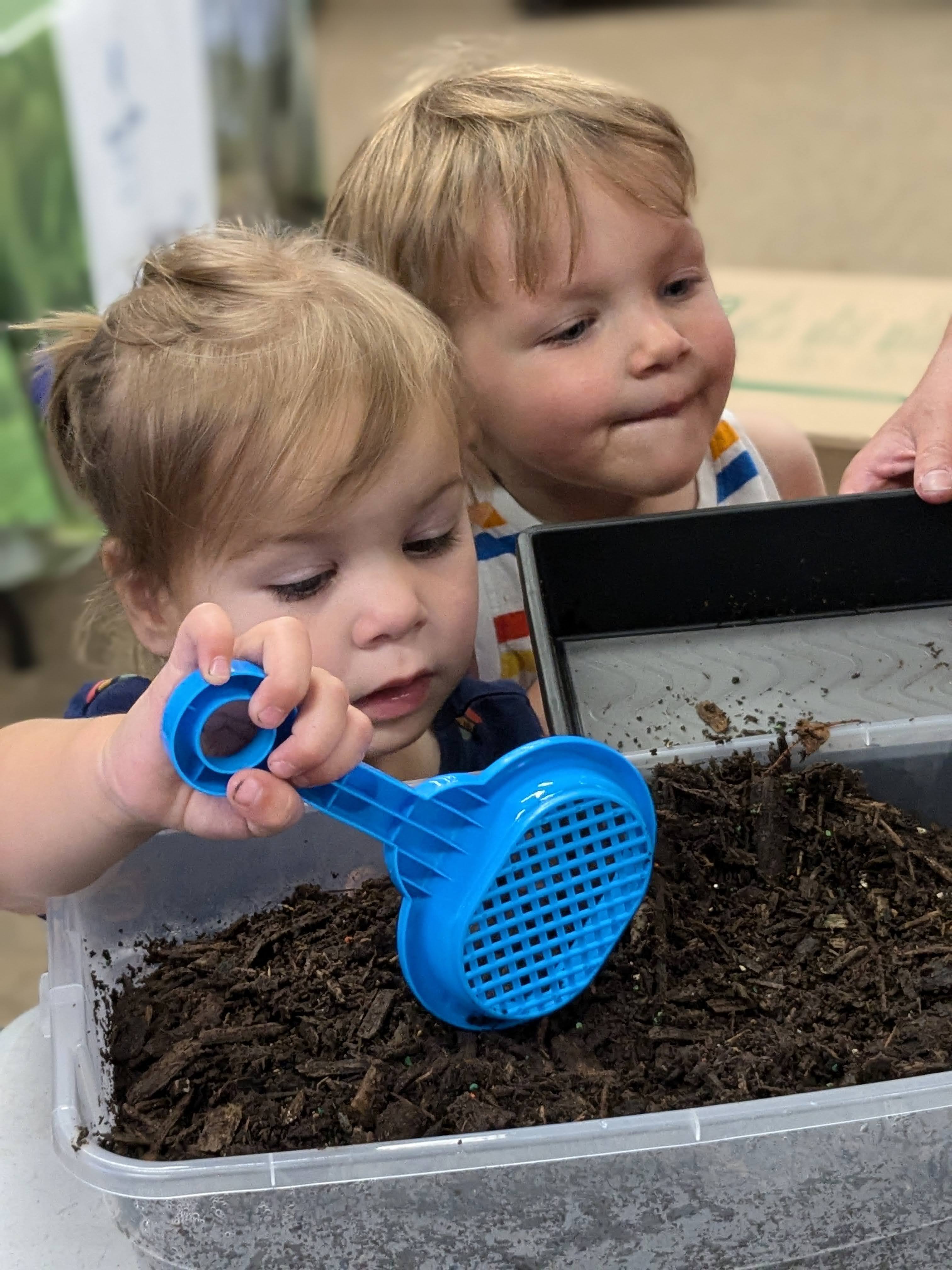 child digging through dirt