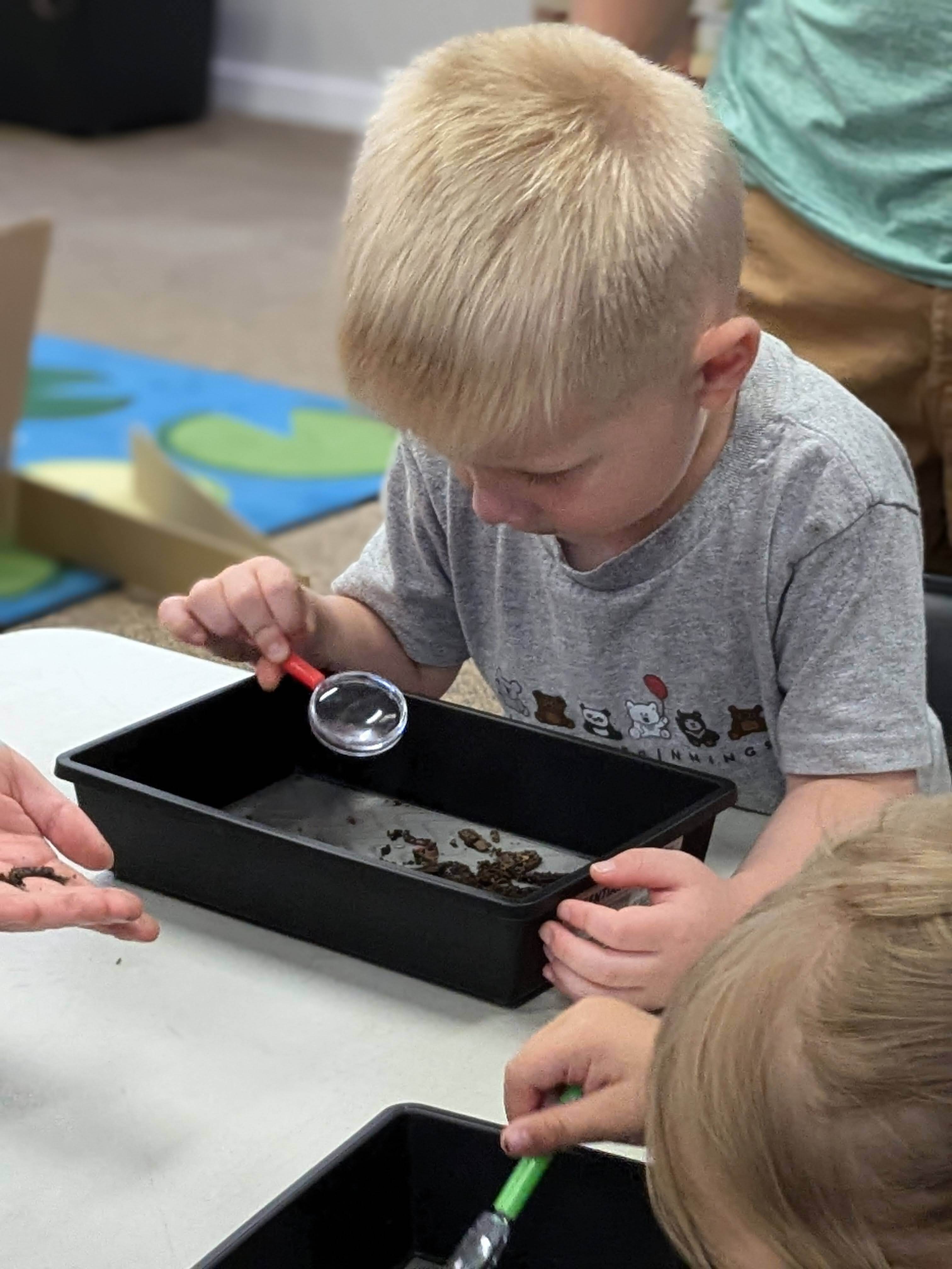 child using a magnifying glass